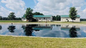 A large building with a green roof and a reflection in a pond. - Homestead Stays, Heart of the area's top attractions (Oak Harbor)