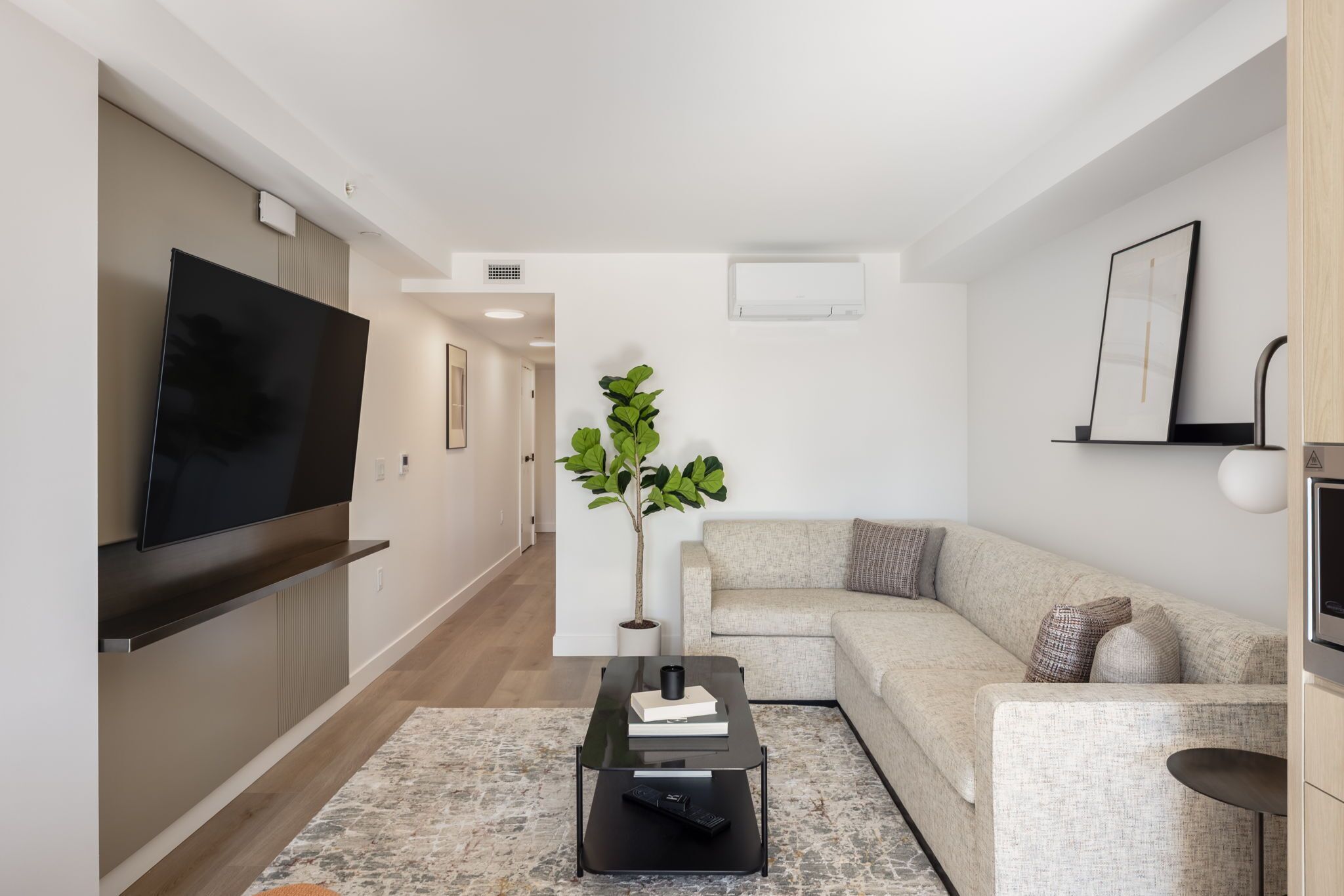 Deluxe Two Bedroom Apartment | Living area | 50-inch Smart TV with cable channels, streaming services