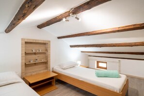 A small, cozy bedroom with a wooden bunk bed, a wooden shelf unit, and a small window. - Villa Olea (Istria - Kaštelir) (Kaštelir)