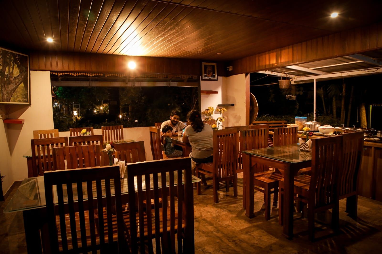 A restaurant with wooden furniture and a view of the outdoors.