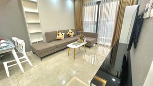 A modern living room with a sofa, a coffee table, and a TV.