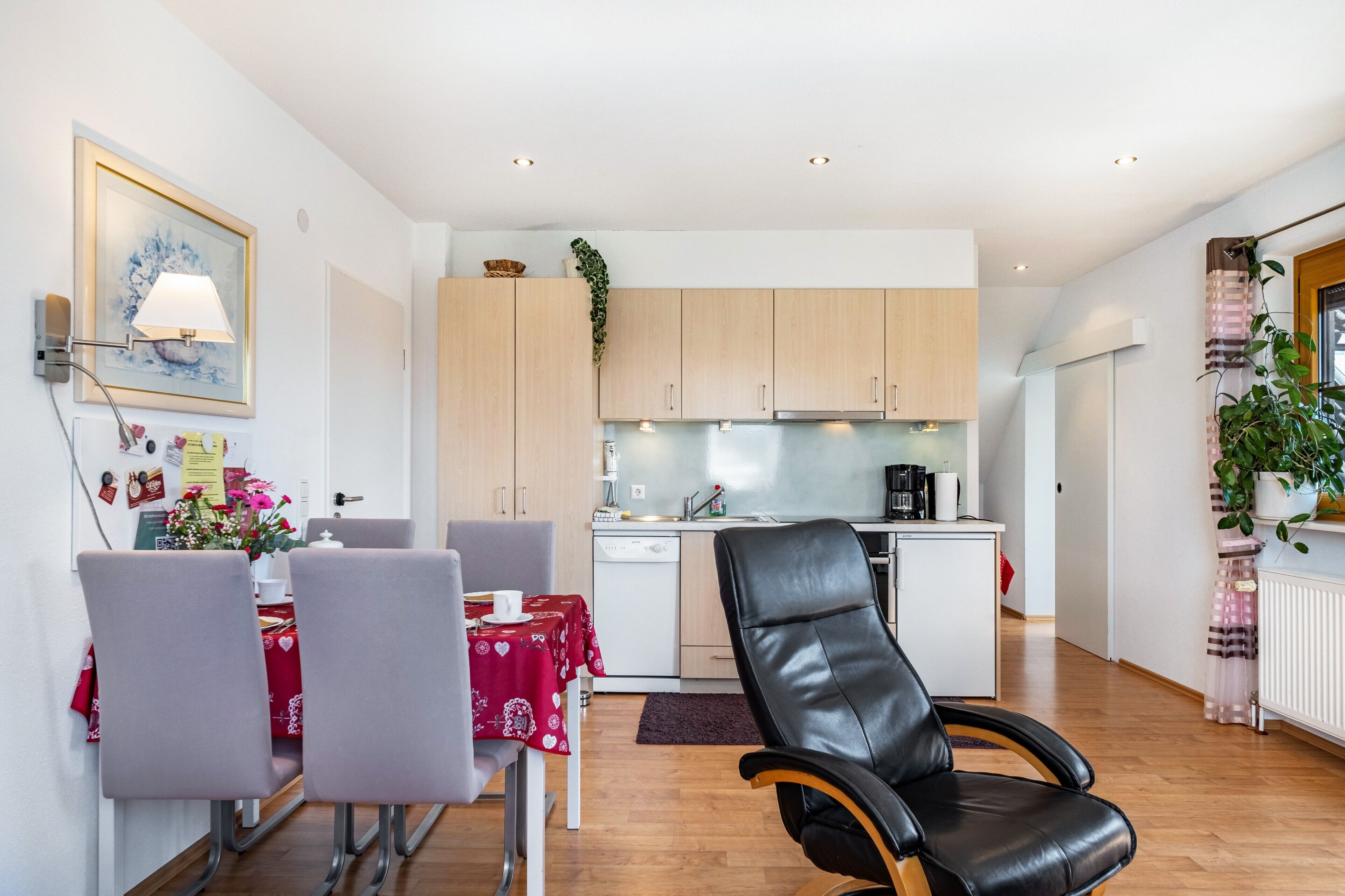 Un espacio habitable compacto con comedor, cocina y zona de estar.