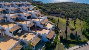 A white building with multiple balconies and a view of the sea. - Sol Beach View Terrace by Interhome (Ferragudo)