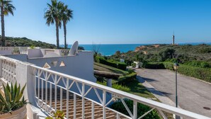 A coastal property with a terrace, palm trees, and a view of the sea. - Sol Beach View Terrace by Interhome (Ferragudo)