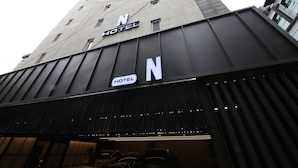 A hotel with a modern design, featuring a prominent 'N' logo on the facade and a sign indicating it is a hotel. - Hwagokhoteln (Seoul)