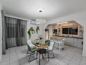 Eine moderne Küche mit weißen Schränken, einer Holzauskładung und einem eingebauten Backofen.