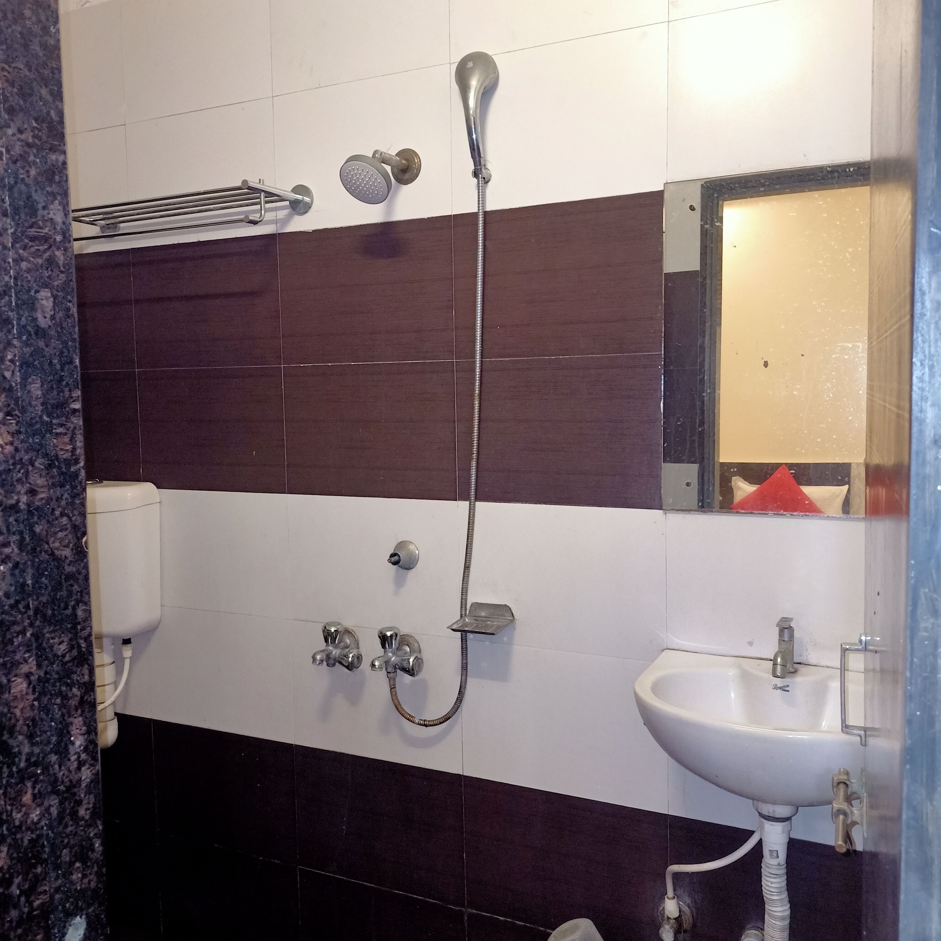 A bathroom with a shower, sink, and toilet.