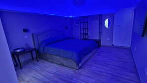 A bedroom with a bed, a bedside table, a wardrobe, and a mirror. - CAMPANILE17 BED AND BREAKFAST 2 BEDS DOUBLE ROOM , 20MT SEA (Manfredonia)
