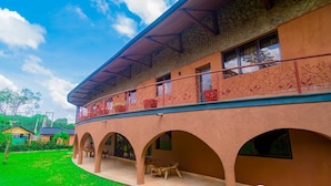 A building with a covered patio area, multiple arches, and a balcony with decorative railings. - Trois Ore Residences  (Ibadan)