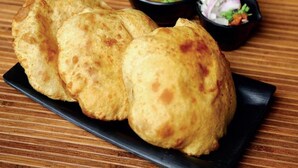 A plate of stuffed bread with a side of soup and salad. - Badrika Farm's (Huzur)