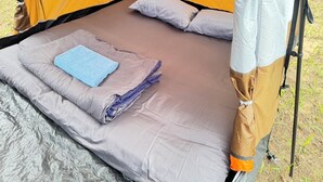 A tent with a sleeping area, including a bed and pillows. - Tent Room Koh Kood (Ko Kut)