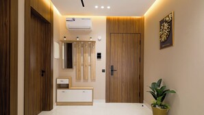 A modern bathroom with wooden doors, a white vanity, a mirror, and a potted plant. - Cozy Elegant Apartment - Rabat Center- Free Parking & AirC & Internet (Rabat)
