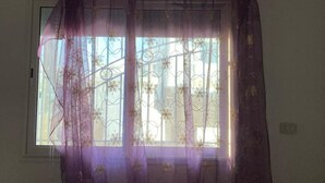 A room with a window covered by sheer purple curtains. - Bagdadi region tourist area Mahdia sea view (Mahdia)