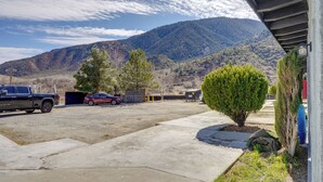 A parking area with a truck and a car, a small tree, and a mountain in the background. - 6 Mi to Frazier Mountain: Cozy Studio Retreat (Frazier Park)