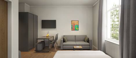 A modern hotel room with a bed, a grey sofa, a desk with a chair, a small table, and a TV mounted on the wall.