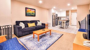 A living room with a sofa, coffee table, and a painting on the wall. - Lakeland Getaway Walk to Lake! (South Lake Tahoe)