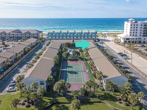 Enjoy a game of tennis on our lush lawn surrounded by palm trees and the ocean in the distance.