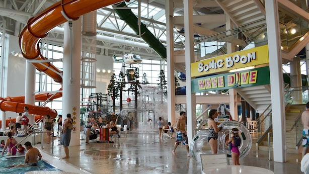 An indoor water park with multiple slides and pools, including a 'Sonic Boom' attraction.