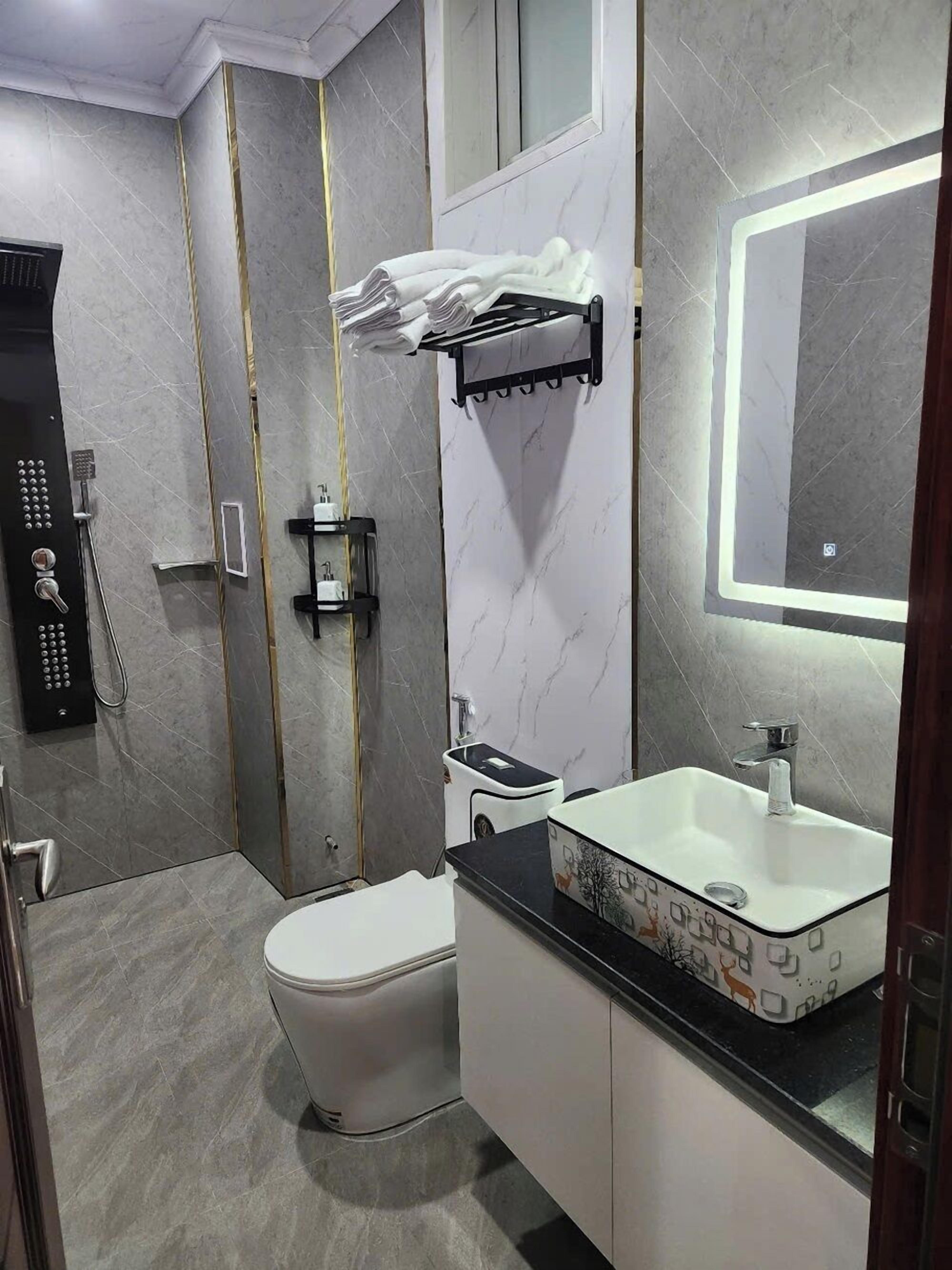 Shower, hair dryer, slippers, towels
