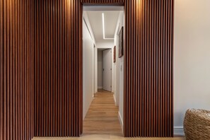 A hallway with wooden paneling and a light fixture on the ceiling. - MAJESTIC SUNSET CONDO ARPOADOR - POSTO 8 - IPANEMA (Copacabana Rio de Janeiro)