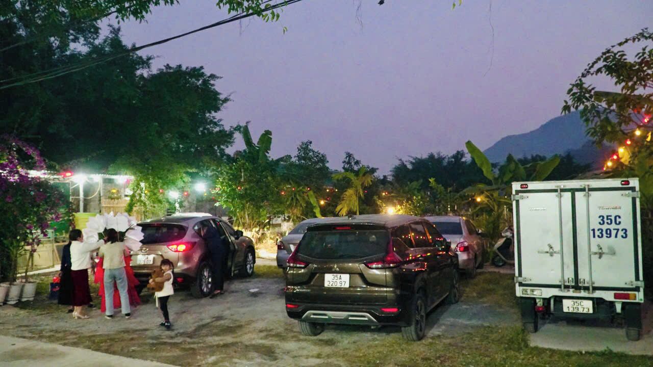 A parking area with several cars and a white delivery truck.