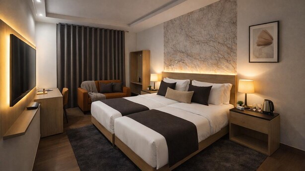 A modern hotel room with a large bed, bedside tables, a desk, a chair, a TV, and a marble wall. - Hotel The Rise (New Delhi)