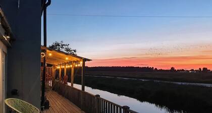 A charming riverside cottage in Upwell, accommodating up to 10 guests.