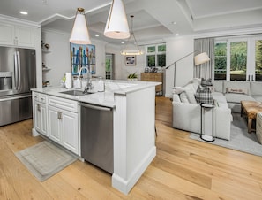 A modern kitchen with white cabinetry, stainless steel appliances, and pendant lighting. - Elegant Modern Residence! Ritz Carlton Vail. Pool, Hot Tub, Short Walk to Slopes (Vail)