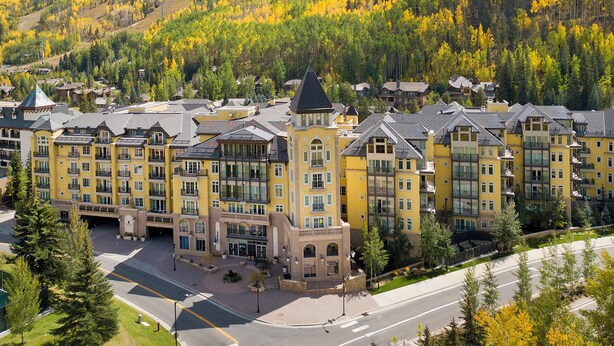 A hotel with multiple buildings, a central tower, and a surrounding mountainous landscape. - Elegant Modern Residence! Ritz Carlton Vail. Pool, Hot Tub, Short Walk to Slopes (Vail)