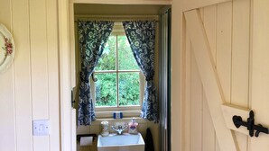 A washroom with a window, a sink, and a toilet. - Lilly's Pad (Bude)