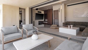 A modern living room with a sofa, chairs, a coffee table, and a TV. - Villa Portokalea, 200m From The Beach, Heated Pool (CHANIA)
