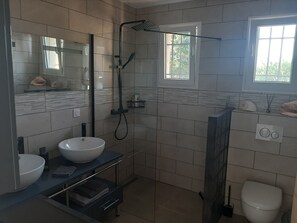Shower, hair dryer, towels, toilet paper