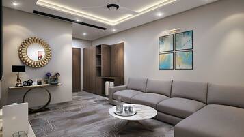 Una sala de estar moderna con un sofá gris, una mesa redonda y un espejo decorativo.