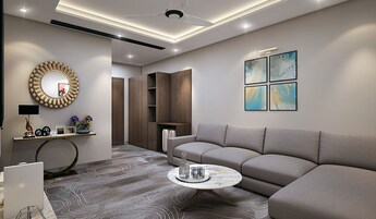 Una sala de estar moderna con un sofá gris, una mesa redonda y un espejo decorativo.
