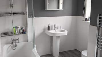 Combined shower/bathtub, hair dryer, towels, soap