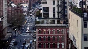 A cityscape with a variety of buildings, including a tall, uniquely designed skyscraper. - Charming 2-bedroom Tribeca apartment with views (New York)