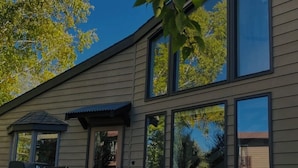 A modern house with a patio, outdoor seating, and a barbecue area. -  Great Montana Townhouse Skiing, Fly Fishing, Golf all in your backyard! (Bozeman)