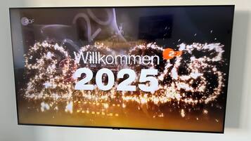 A television screen displaying a welcome message for the year 2025.