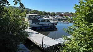 A marina with boats docked, surrounded by greenery and hills in the background. - Comfort vacation apartment NeuBau Merzig (Merzig)