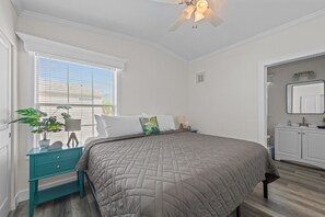 A bedroom with a bed, a nightstand, a dresser, a ceiling fan, and a window with blinds. - Sunny Gulf Coast Getaway-Near Beach-Shared Pool! (Fort Myers Beach)