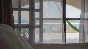A room with a large window overlooking a pool area.