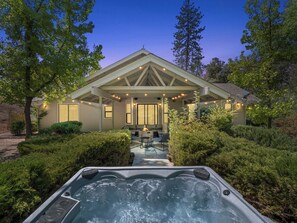 A house with a covered patio, a hot tub, and a well-maintained garden. - Sleeps 30 - Spacious - 3 Houses on 40 acres - Hot Tub - Game Room (Ahwahnee)