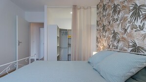 Une chambre à coucher avec un lit, une armoire et une salle de bain.