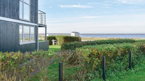 A modern building with large windows overlooking a coastal area. - Cozy home in Hemmet with WiFi (Hemmet)