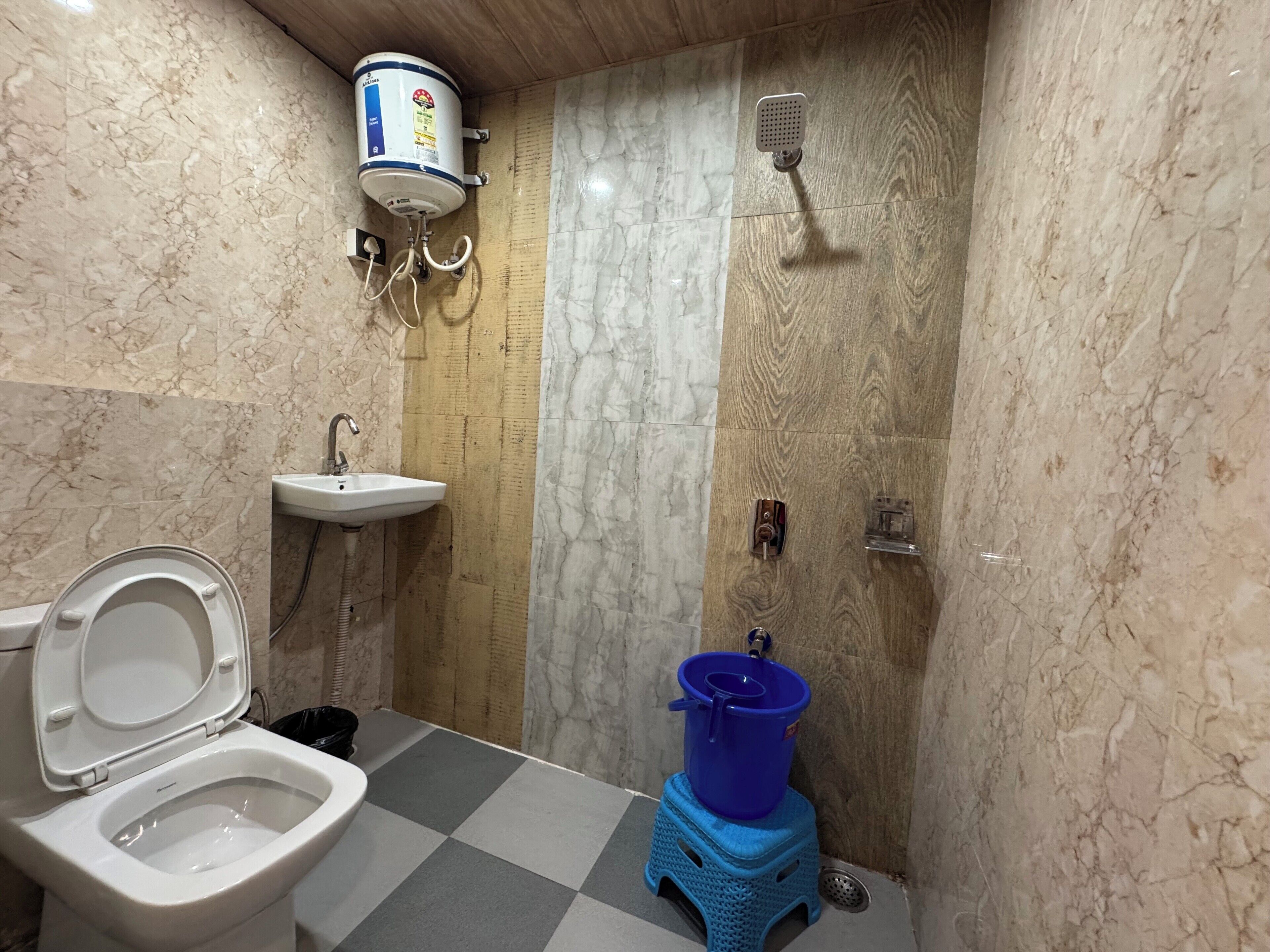 A compact bathroom with a toilet, sink, and shower.