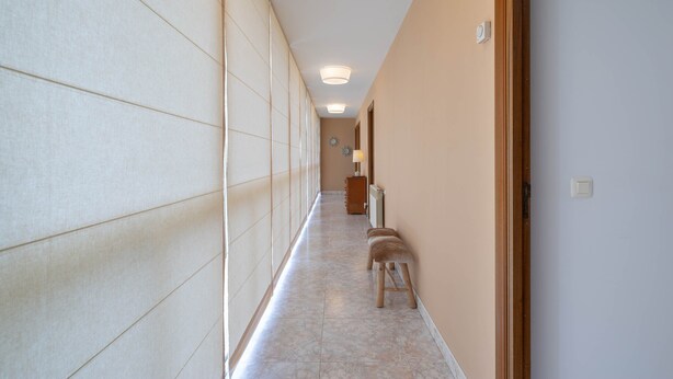 A hallway with a bench, a radiator, and a door. - Country House 'Casa Da Carballeira' with Mountain View, Private Garden and Wi-Fi (A Estrada)