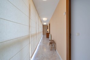 A hallway with a bench, a radiator, and a door. - Country House 'Casa Da Carballeira' with Mountain View, Private Garden and Wi-Fi (A Estrada)