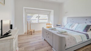 A bedroom with a bed, a chair, a desk, and a window. - Holiday Home 'La Ferme D'Alcide' with Private Terrace, Private Garden and Wi-Fi (Québriac)