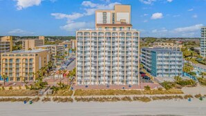 A high-rise hotel with multiple floors, a central atrium, and a beachside location. - Sea Mist 50504 (Myrtle Beach)