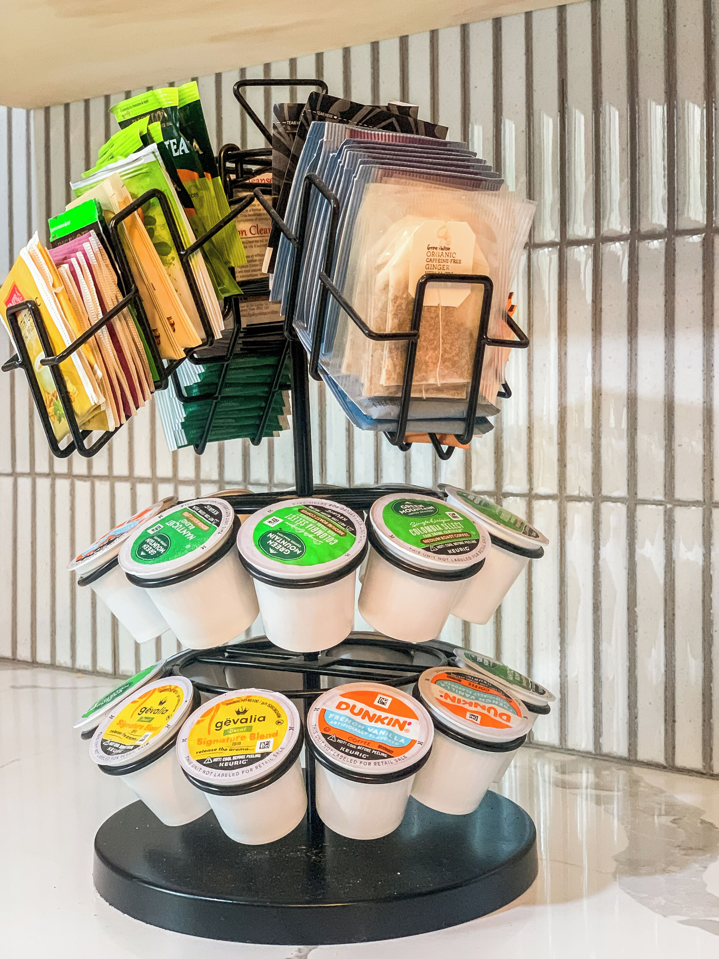 A display stand with various tea bags and coffee pods.
